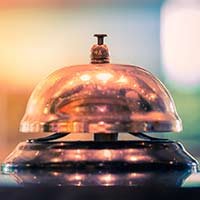 Shiny bell sitting on the table.